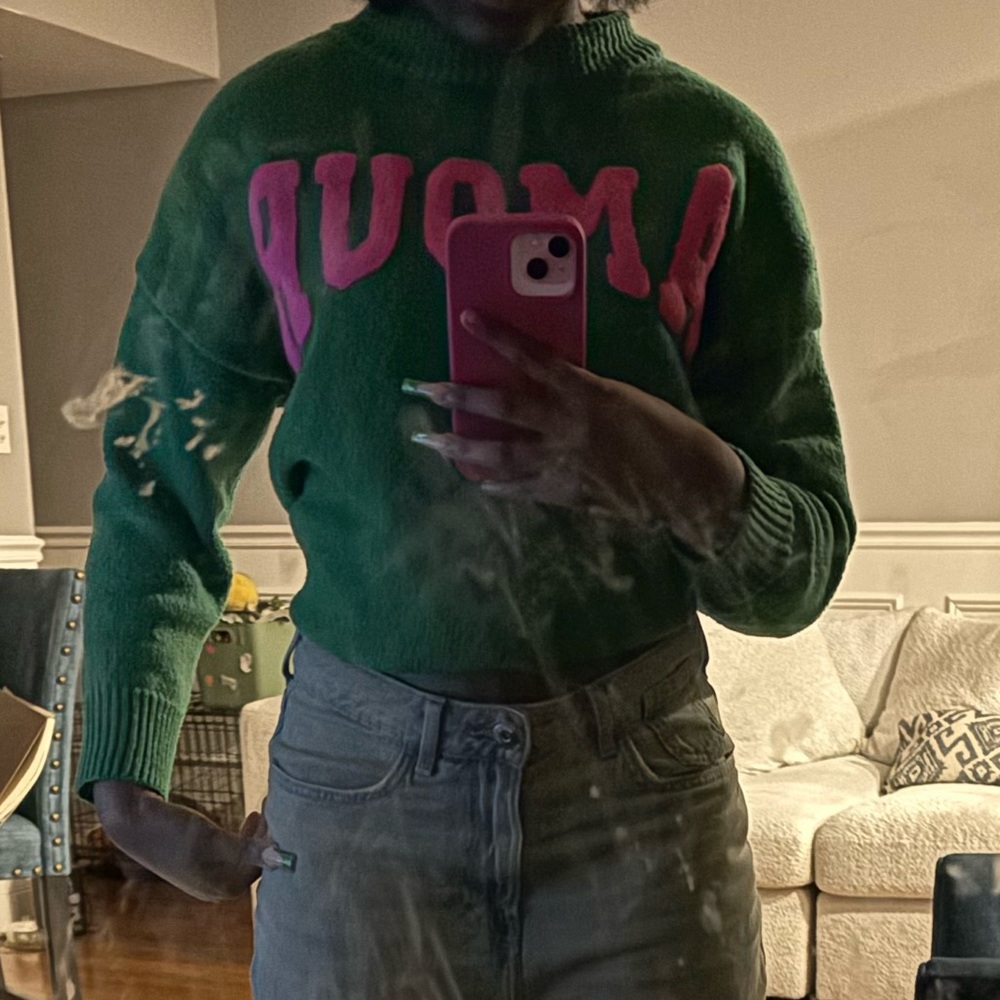 Green turtleneck sweater that say amour.